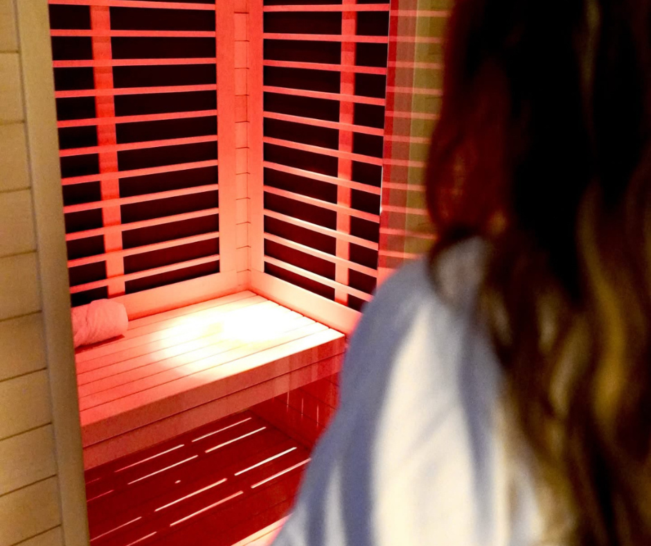 Woman walking into red -light therapy room